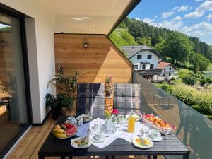a table with food on top of a balcony at Appartement Dürnle Reißeck in Mühldorf
