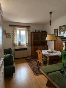 a living room with a table and a couch at Landhaus Sunnberg in Gersdorf