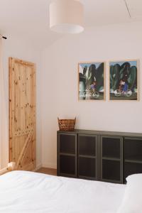 a bedroom with a bed and a wooden door at Apartamenty Wrzosowa 23 z garażem na rowery in Kudowa-Zdrój +102 photos