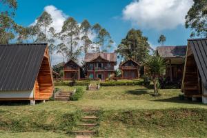 a house in the middle of a yard at TB Villa Resort By ARBA in Palayangan