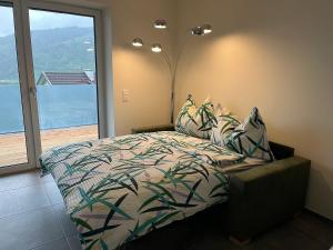 a bedroom with a bed and a large window at Appartement Dürnle Reißeck in Mühldorf