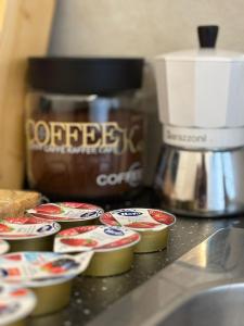 a counter top with cupcakes and a coffee maker at Milano side house apartment in Sesto San Giovanni +1 photo