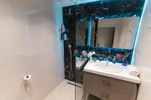 a bathroom with a sink and a mirror at Unique Kos Apartment in Ampavris +19 photos