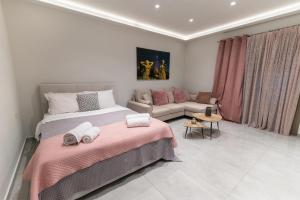 a bedroom with two beds and a couch at Unique Kos Apartment in Ampavris
