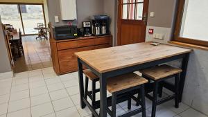 a kitchen with a wooden table and stools at La Valdonnière in Esnoms-au-Val +27 photos