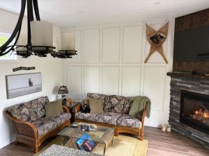 a living room with two couches and a fireplace at Hidden Getaway in Pembroke