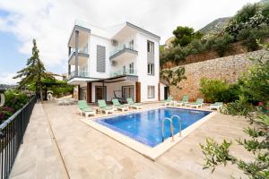 a villa with a swimming pool and a house at Villa Mevsim in Kaş