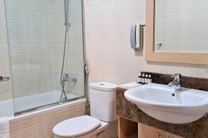 a bathroom with a sink and a toilet and a shower at Barceló Residences Dubai Marina in Dubai