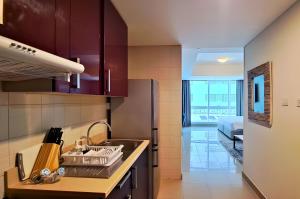 a kitchen with purple cabinets and a sink at Barceló Residences Dubai Marina in Dubai