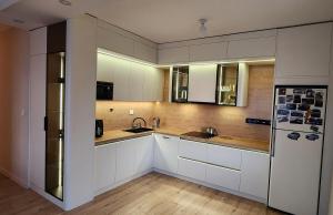 a kitchen with white cabinets and a refrigerator at "Private Room in New Luxury " Apartment in Ulaanbaatar
