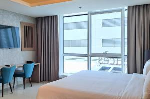 a hotel room with a large bed and a table and chairs at Barceló Residences Dubai Marina in Dubai +87 photos