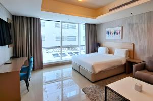 a hotel room with a bed and a living room at Barceló Residences Dubai Marina in Dubai