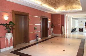 a large room with red walls and a vase on the wall at Hotel Olympia Palace in Olympia