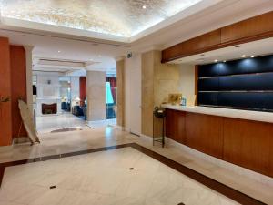 a lobby with a reception desk and a fireplace at Hotel Olympia Palace in Olympia