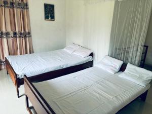 two twin beds in a room with curtains at Cloud Nine in Diyatalawa +39 photos