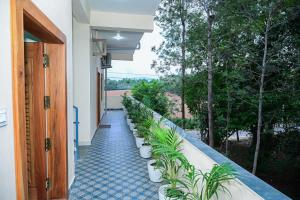 a hallway with plants on the side of a building at Coorg Manam Homestay in Kushālnagar