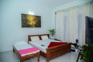 a bedroom with a bed and a table at Coorg Manam Homestay in Kushālnagar