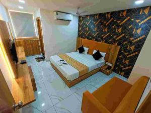 a hotel room with a bed and a couch at HOTEL ROCK In in Anand
