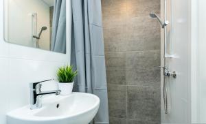 a bathroom with a sink and a shower at Sõle Studios by RevalHome in Tallinn