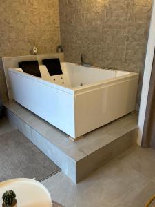 a white bath tub sitting on a shelf in a room at L atelier de Jules in Lyon