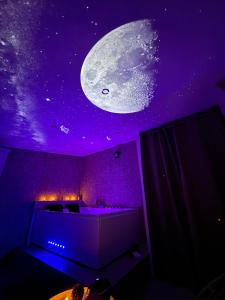 a room with a mural of the moon on the ceiling at L atelier de Jules in Lyon