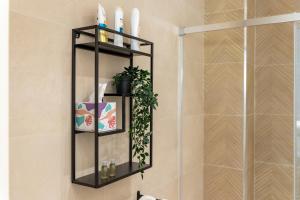 a bathroom with a black shelf next to a shower at la perla sul mare in Sampieri