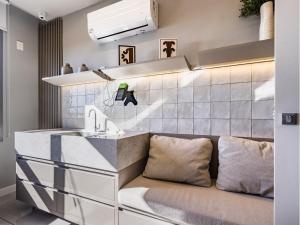 a kitchen with a sink and a couch at Connect João Wallig by My Way in Porto Alegre