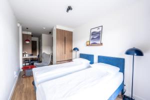 a bedroom with two beds and a desk at Noli Gdansk Wrzeszcz in Gdańsk +120 photos