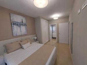 a bedroom with a large white bed in a room at Playa Torre de la Sal - Primera Linea in La Estación +30 photos