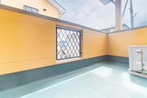 an empty room with a window and a fence at Coucou! in Takasaki