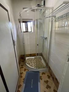 a shower with a glass door in a bathroom at Elimisam stays in Kitwe +10 photos