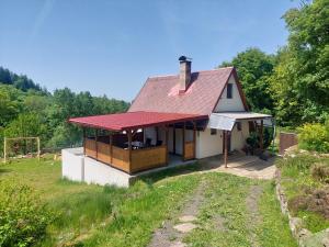 a small white house with a red roof at Chata Kamenice in Kamenice