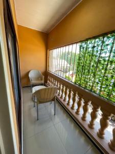 a balcony with a bench and a window at Elimisam stays in Kitwe