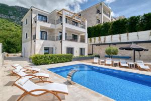 a house with a swimming pool next to a building at Quercus Villa 2 in Blizikuće
