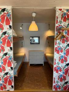 a bedroom with two bunk beds and a mirror at Svens Stuga in Burträsk