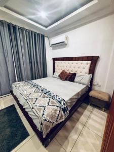 a bedroom with a bed in a room at Saffron Nest in Zirakpur