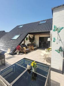 a house with a swimming pool and a roof at Vaerthof in Diepenbeek