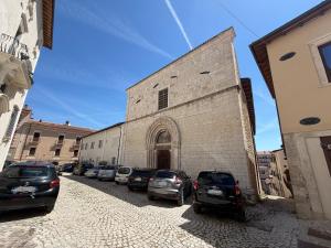 a group of cars parked in front of a building at Casa Cloe in LʼAquila