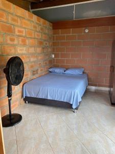 a room with a bed in a brick wall at Finca Panoramica in Barbosa +21 photos