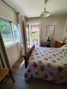 a bedroom with a bed with a cow patterned comforter at Le petit nid dans les bois in Castres-Gironde