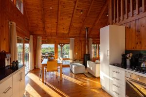 a kitchen and living room with wooden walls and wooden floors at Reflections Eco-Reserve in Wilderness +19 photos