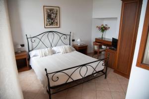 a bedroom with a bed and a desk and a piano at Villa Govi in Diano Castello