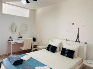 a white bedroom with a bed and a desk with a chair at Villa Madeira in Silves +78 photos