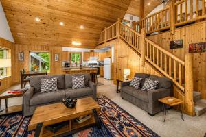 a living room with two couches and a staircase at Pine River Retreat in Leavenworth +56 photos