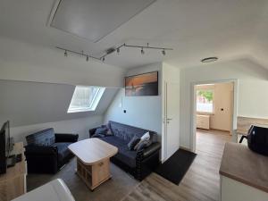 a living room with a couch and a table at Ferienwohnung Bruhn in Meldorf