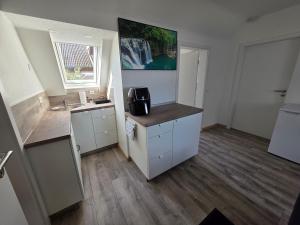 a small kitchen with a sink and a counter at Ferienwohnung Bruhn in Meldorf +10 photos