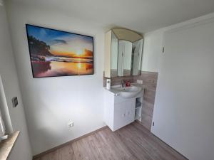 a bathroom with a sink and a mirror at Ferienwohnung Bruhn in Meldorf