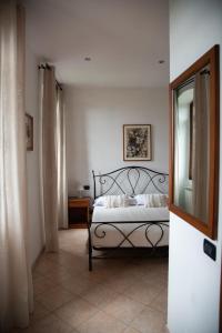 a bedroom with a bed and a mirror at Villa Govi in Diano Castello