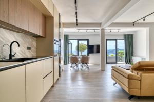 an open kitchen and living room with a couch at Quercus Villa 2 in Blizikuće