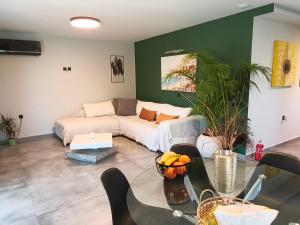 a living room with a couch and a table at Villa secrecy in Lixouri